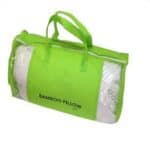 A green bag with the word bamboo pillow on it.