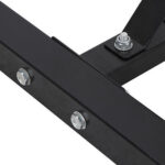 A close up of a black metal bracket with screws.