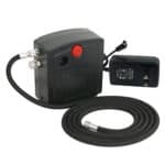 A portable air compressor with a hose attached to it.