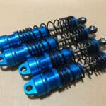 A set of blue and black springs on a table.