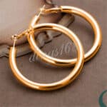 A pair of gold plated hoop earrings.