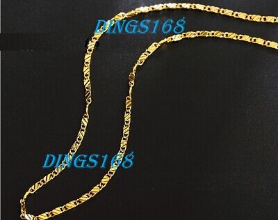 A gold plated chain on a black background.