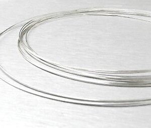 A pair of silver wires on a white surface.