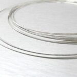 A set of silver plated bangles on a table.