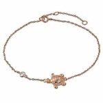 A rose gold bracelet with a turtle charm.