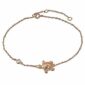 A rose gold bracelet with a turtle charm.