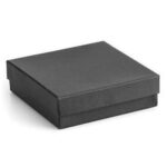 A black jewelry box on a white surface.