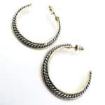 A pair of gold and silver hoop earrings.