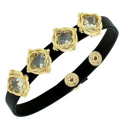 A black leather bracelet with gold and crystal accents.