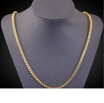 A gold chain necklace on a mannequin.