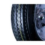 A close up of a truck tire on a white background.