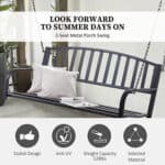 A metal porch swing with pillows and a newspaper.