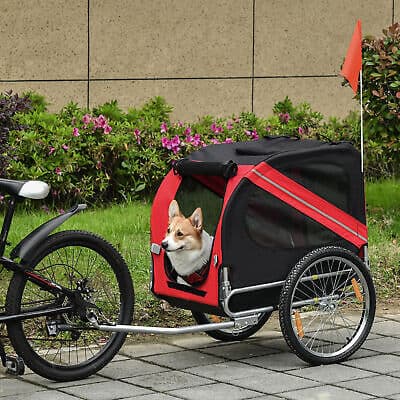 A dog in a bicycle trailer.