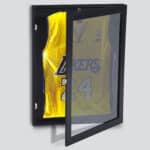 A basketball jersey in a glass case.