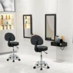 A beauty salon with two stools and mirrors.