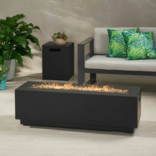 A black outdoor fire pit on a patio.
