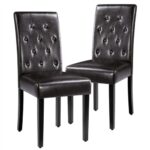 A pair of black leather dining chairs.