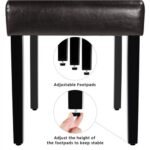 An image of a piano stool with a hand on it.