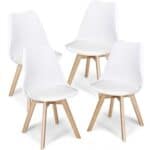 Four white dining chairs with wooden legs.