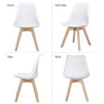 A set of four white dining chairs with wooden legs.