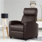 A modern brown recliner chair in a living room with a side table and lamp.