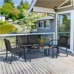 A cozy and sunny home patio with outdoor furniture.