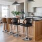 Modern kitchen interior with a breakfast bar and stylish stools.