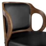 Modern wooden chair with black leather upholstery.