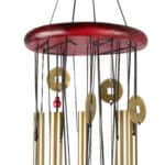 A wind chime with metal tubes and wooden elements hanging from a circular top.