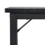 Close-up view of a black table corner showing the edge and leg.