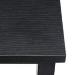 Close-up view of the corner of a black wooden table showing texture details.