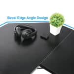 A pair of headphones and a small potted plant on a desk featuring a bevel edge angle design.