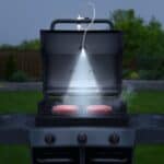 A bbq grill with smoke coming out of it.