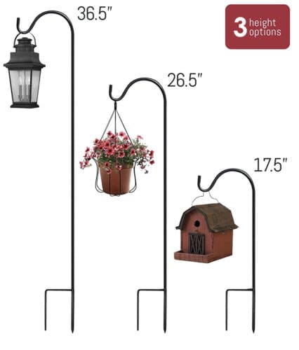 A set of three plant stands with different sizes of pots and lanterns.