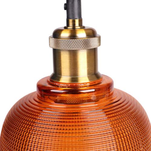 An orange glass pendant light with a brass base.
