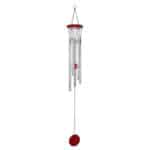 A red wind chime hanging on a white background.