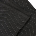 A black chevron pattern on a piece of fabric.