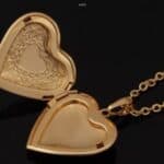 A heart shaped locket with a gold chain.