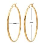 A pair of gold hoop earrings with measurements.