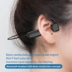 A woman wearing a bluetooth earphone with the text bone conduction hearing aid.