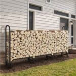 A stack of firewood in front of a house.