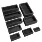 A set of black plastic molds on a white background.