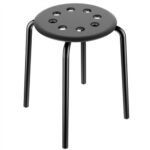 A black stool with holes on it.