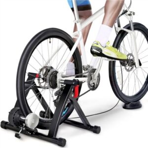A person is standing on a bike trainer.
