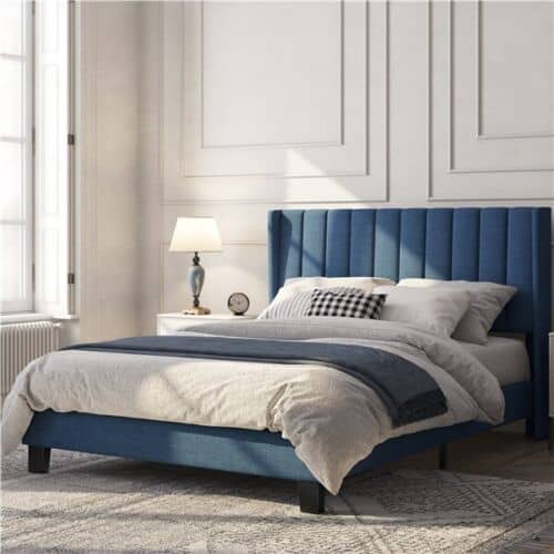 A blue upholstered bed in a bedroom.
