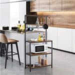 A kitchen with a microwave and stools.