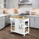 A white kitchen cart on wheels in a kitchen.