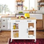 A kitchen with a cart and food on it.