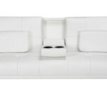 A white couch with two pillows.