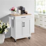 A white kitchen cart with a coffee machine on top.